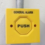 Photo of a yellow General Alarm button.